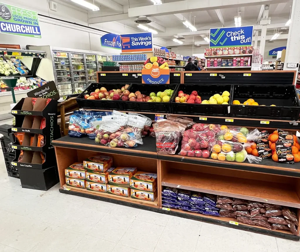 produce stand in Northern Store. Stand has apples, oranges and pears