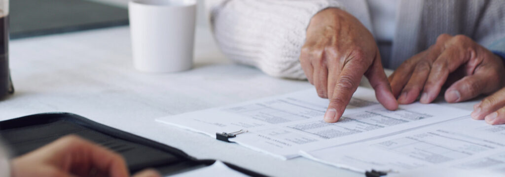 two people looking over papers