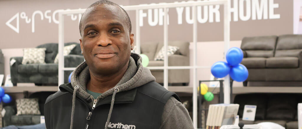 Northern employee standing in from of Home Furnishings display